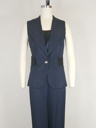 Image may contain Clothing Formal Wear Suit Blazer Coat Jacket Vest Adult Person Tuxedo and Pants