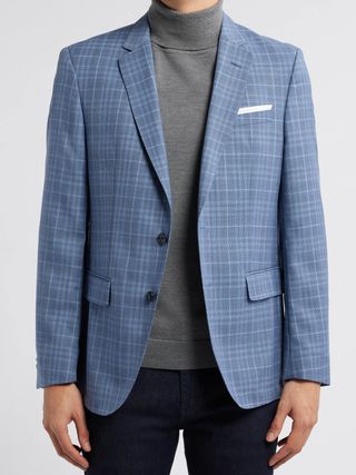 Image may contain Blazer Clothing Coat Jacket Formal Wear and Suit