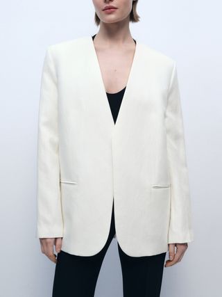 Image may contain Blazer Clothing Coat Jacket Formal Wear Suit Tuxedo Home Decor and Linen